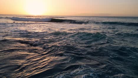 Aerial-view-of-the-ocean-surface-at-sunset