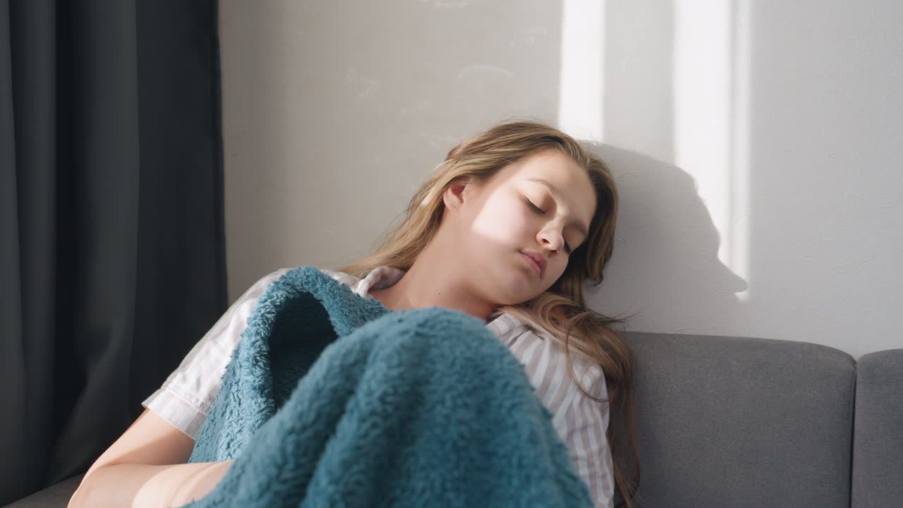 Calm Woman Indoors, Relaxed Woman Peacefully Enjoying Gentle Sunlight Within Cozy Space, Content Lady Comfortably Enjoying Soft Sunlight Filtering Through Her Quiet Indoor Environment