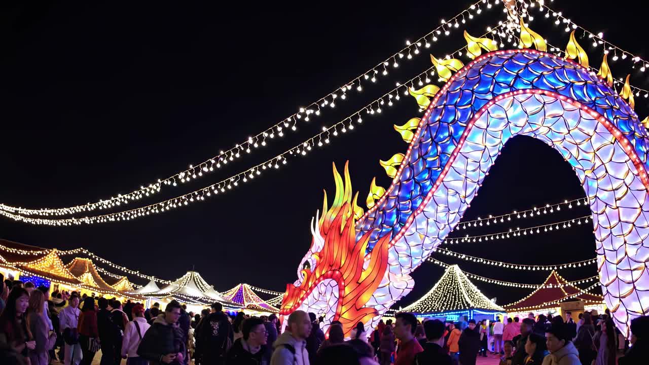 A vibrant night festival video scene featuring a colorful dragon lantern