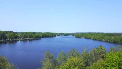 Majestic-aerial-top-view-flight-Natural-Summer-Paradise-idyllic-Island-in-Lake,-Chlum-in-Czech,-day-2023