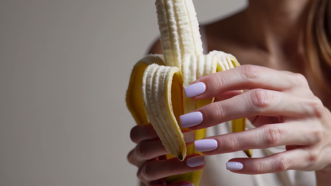 Woman peeling a banana