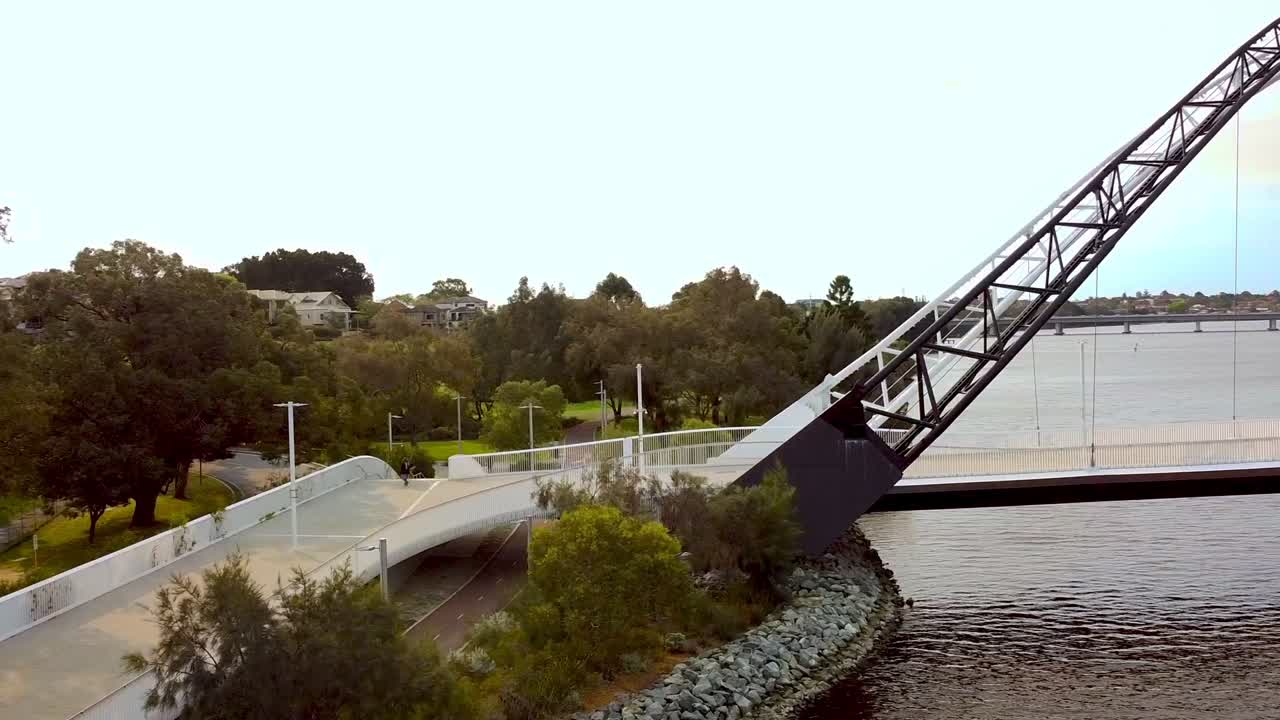 Cyclist riding over the Matagarup Bridge over the Swan River towards the Optus Stadium