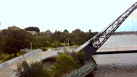 cyclist riding over the matagarup bridge over the swan river towards the optus stadium