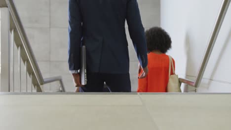 diverse business people going down stairs at office, slow motion