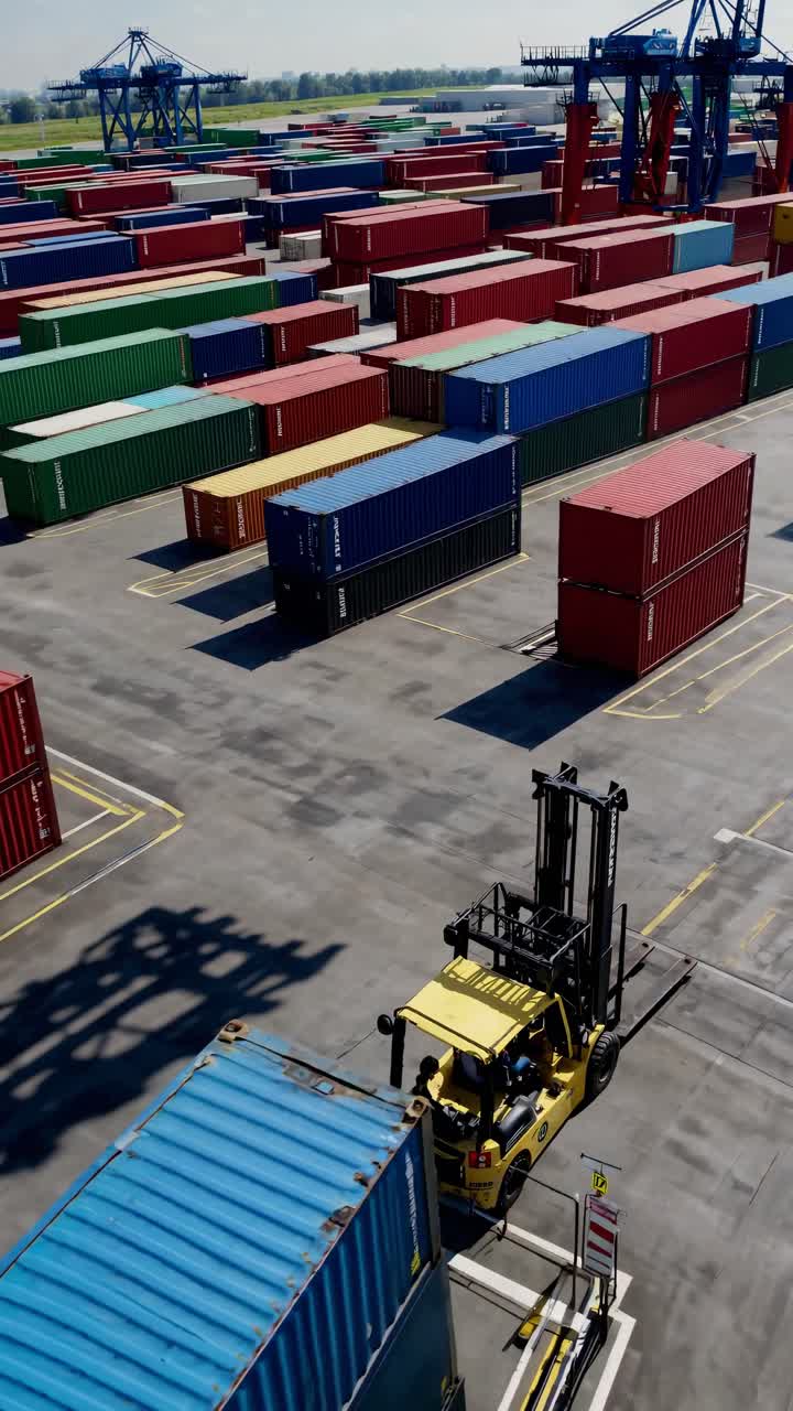 Aerial View of Forklift Moving Containers in a Busy Shipping Terminal