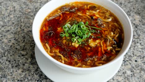 close up circle movement of sichuan hot and spicy soup in a bowl, chinese food or taiwan food in the restaurant