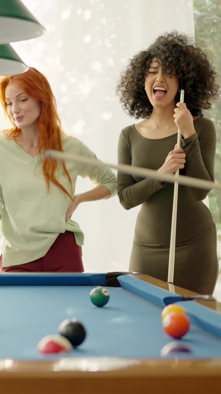 Friends having nice rivalry playing pool together at home