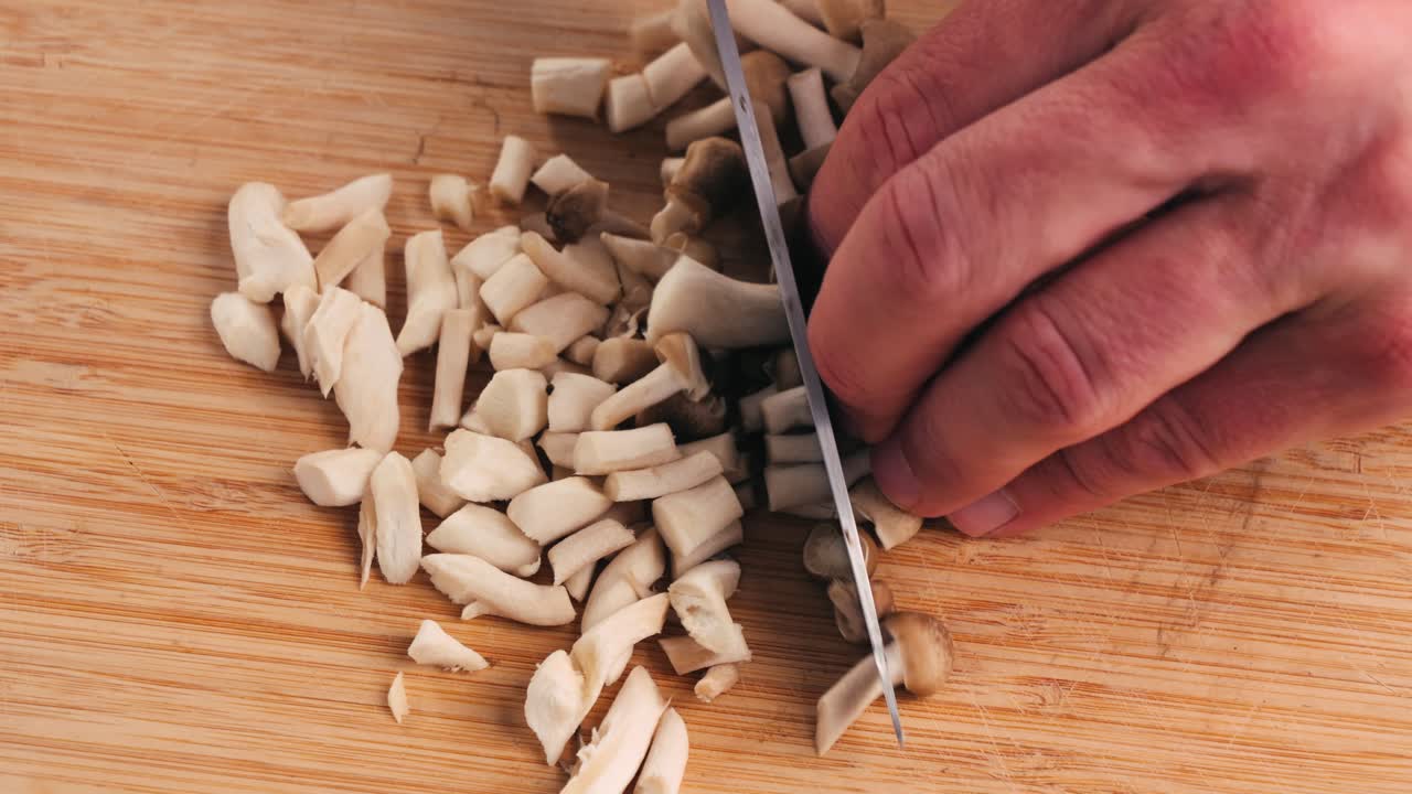 Chopping Mushrooms on a Wooden Cutting Board