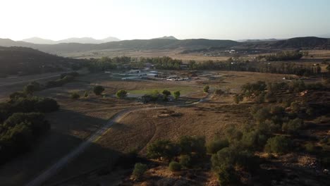 Beautiful-cinematic-evening-drone-shot-of-dirt-roads-and-small-farms-on-Kumeyaay-Native-American-Reservation-in-Southern-California