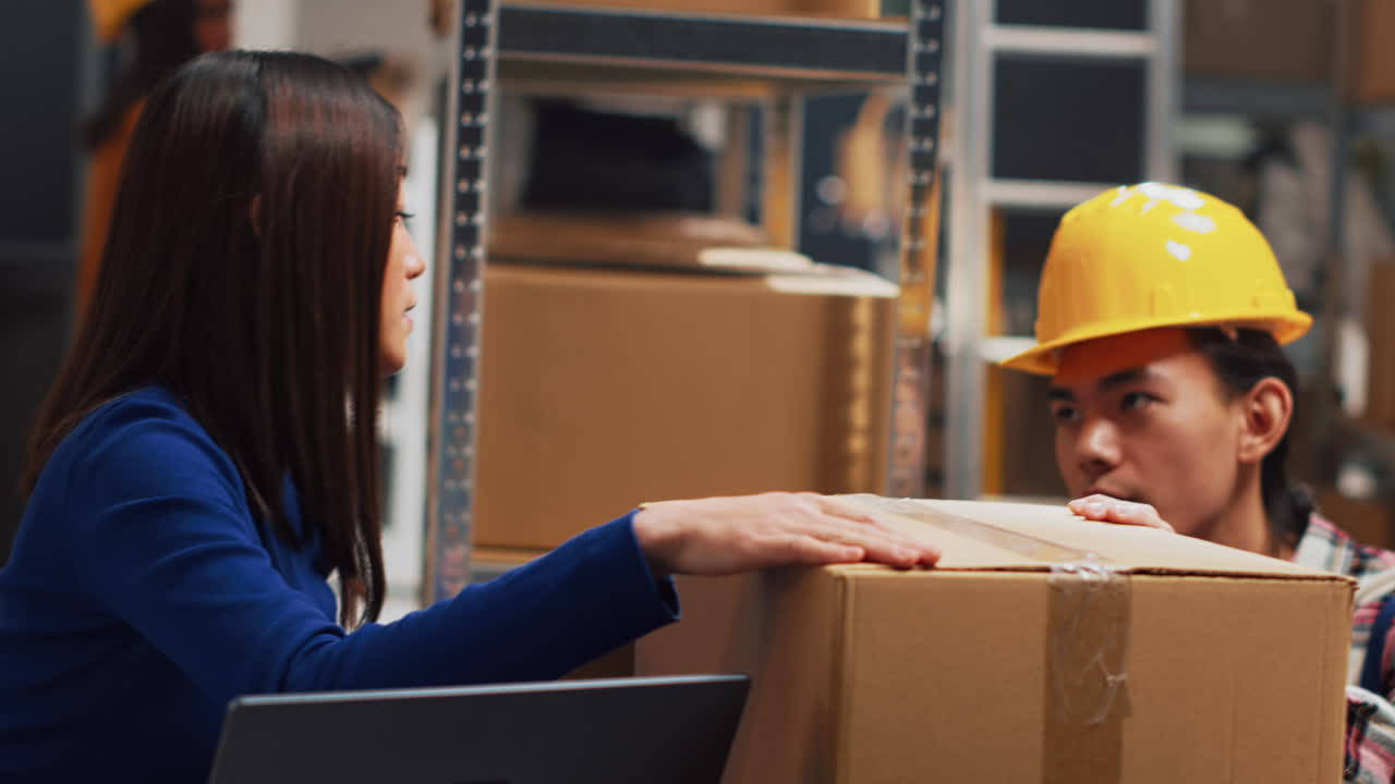 Warehouse employees working with boxes and inventory