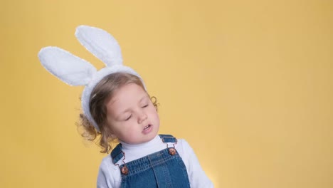 portrait of a cute little girl dressed in ears easter bunny, happy baby waiting for the holiday
