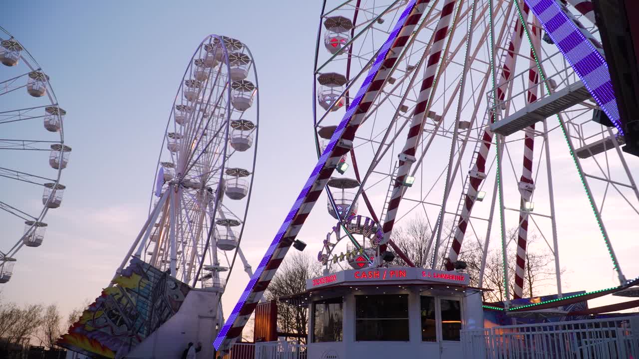 Multiple Ferris Wheels Spinning at Manufacturer of Fairground Attractions, Dusk
