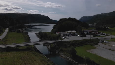 aerial view of norwegian landscape with bridge and scenic fjord in nordland - drone shot
