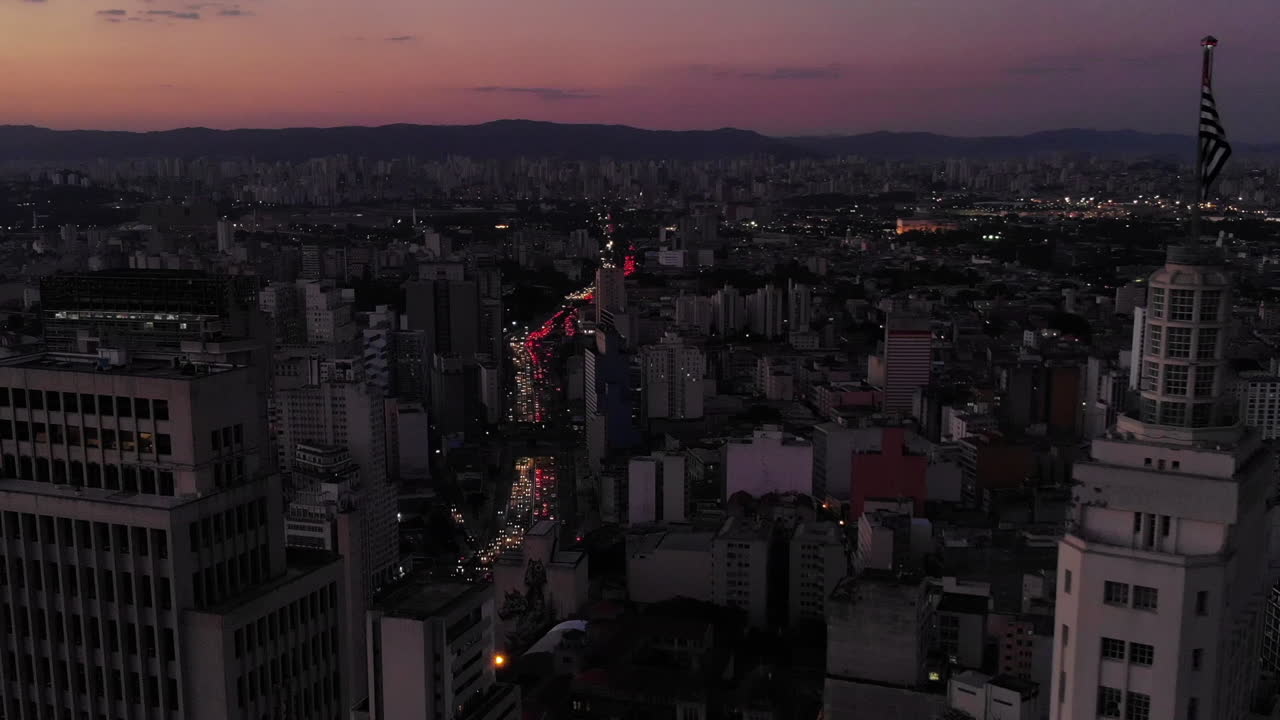 Aerial view of Altino Arantes building, called Banespao with the flag fluttering, at sunset, Sao Paulo downtown, Brazil