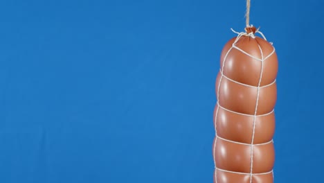 a whole stick of boiled sausage hanging.