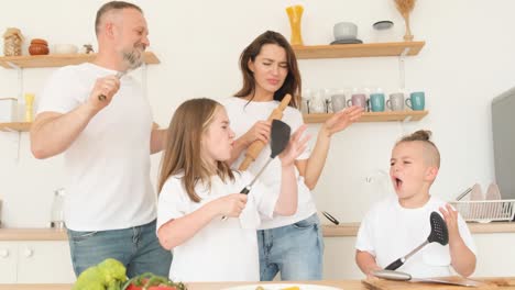 Dancing Family in the Kitchen with two Children Dancing Family in the Kitchen with two Children Family Look Happy Family Weekend