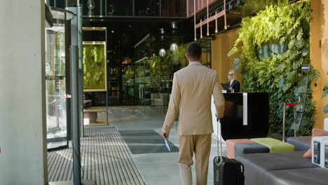 blonde receptionist at the entrance of a hotel