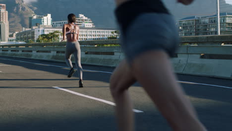 women running on city bridge