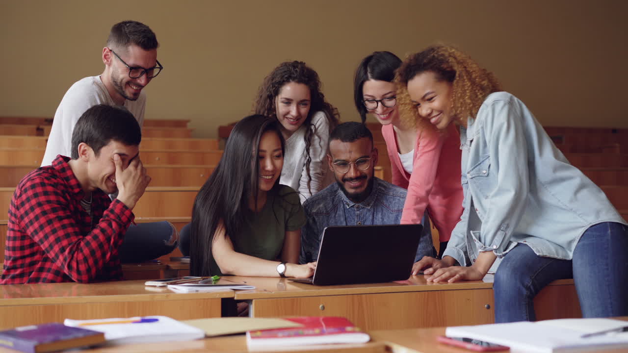 Students in a classroom using a laptop