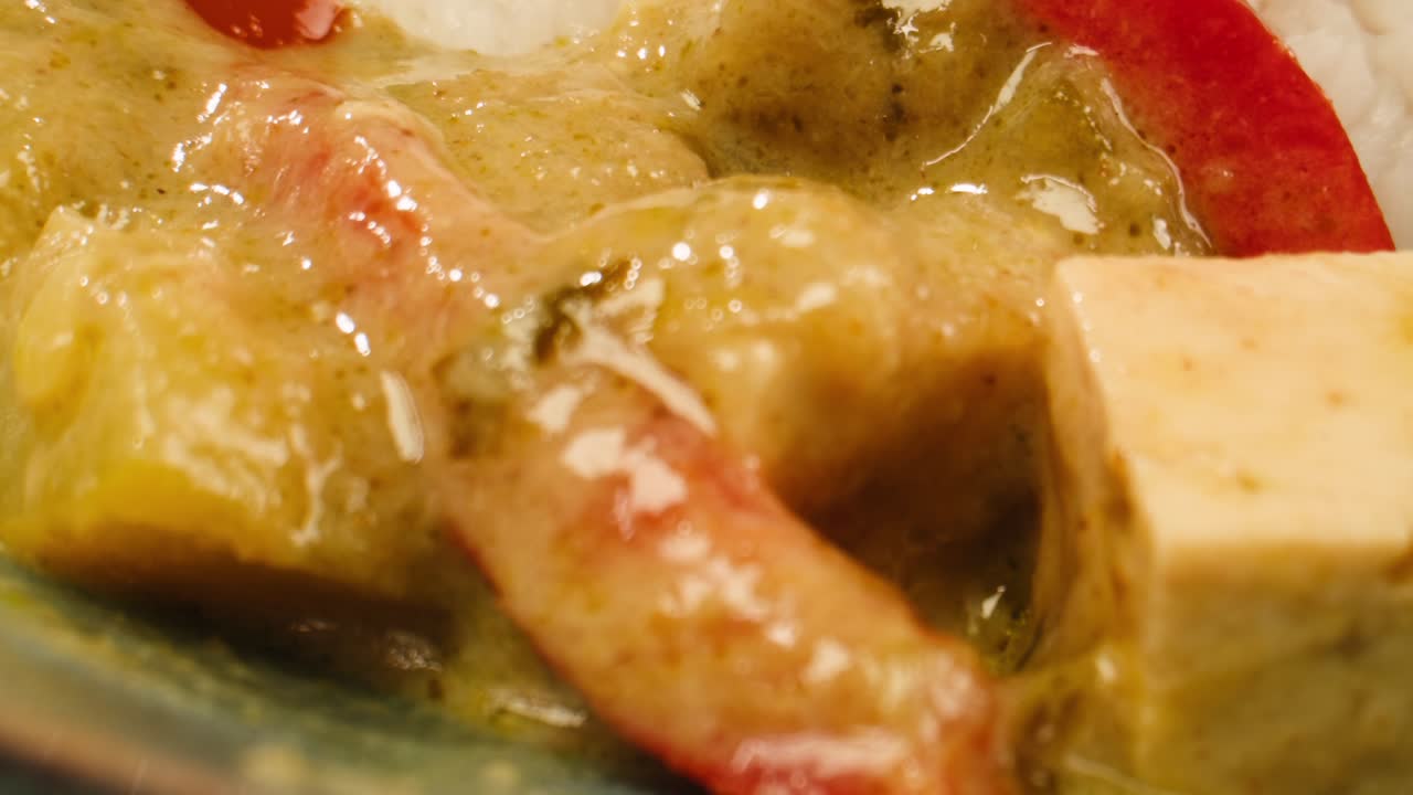 Close-up of Green Curry with Tofu and Red Pepper