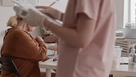 female doctor giving injection to patient