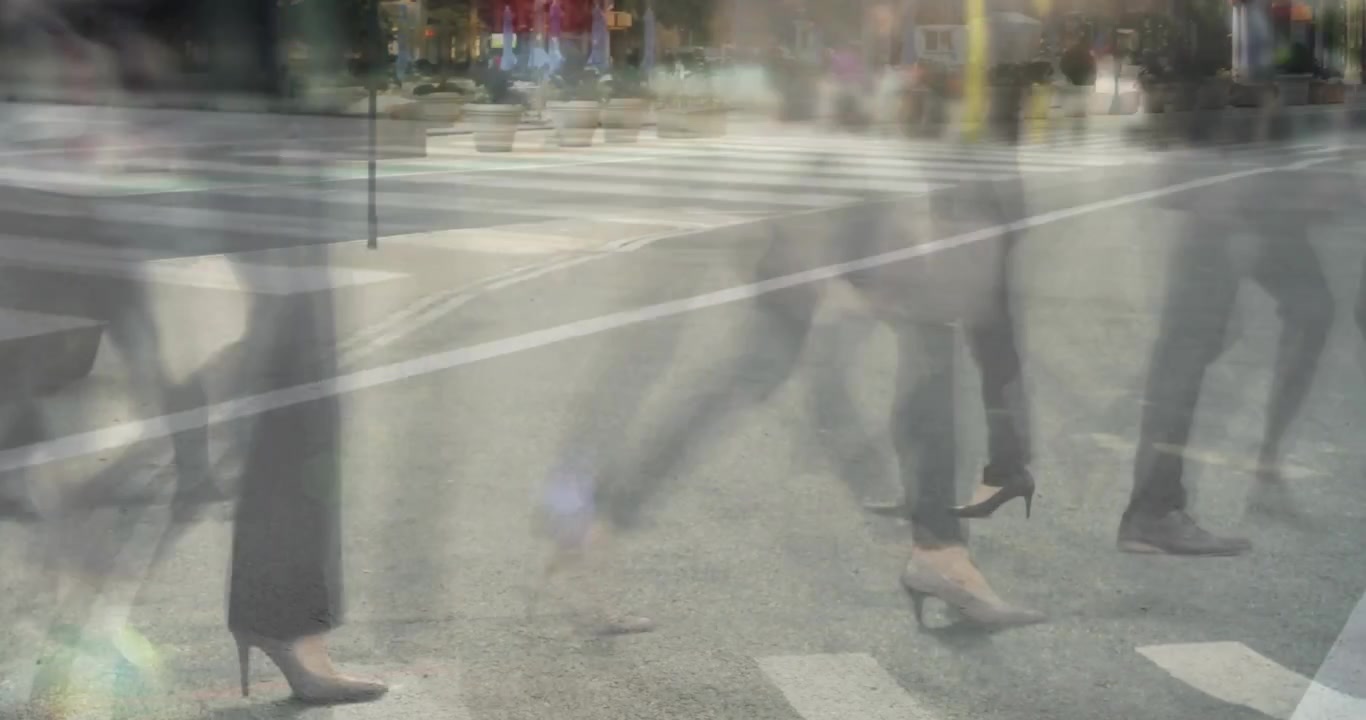 Walkers crossing crosswalk after signal change showing ghosted layered feet for traffic design