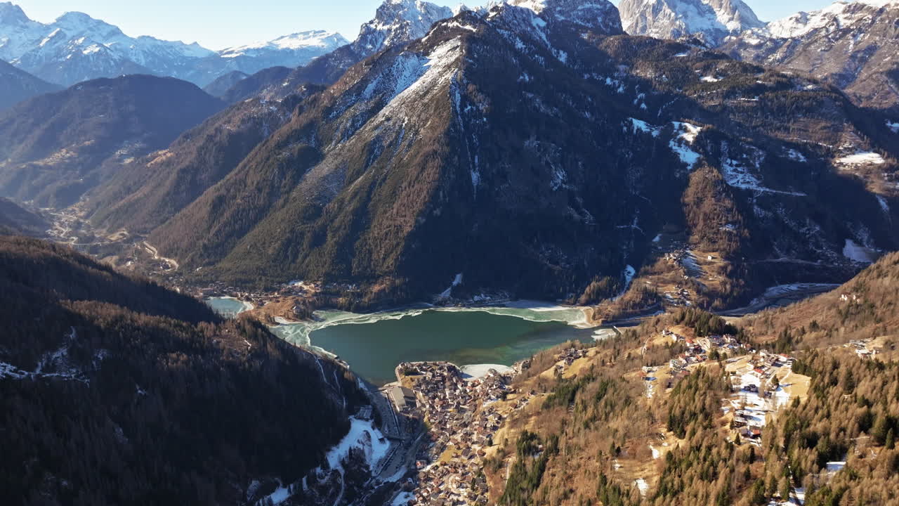 Aerial drone view of the Alleghe village with Lake Alleghe, in the province of Belluno, Dolomites, Italy