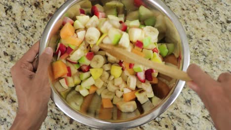 Mixing-healthy-fruit-salad-rich-with-vitamins-and-nutrition