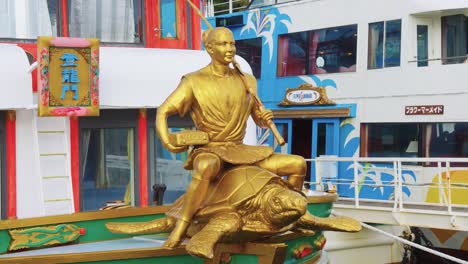 statue of urashima taro, japanese fairy tale character as figurehead of boat