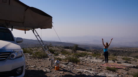 western traveler girl practicing outdoor yoga in oman, different poses in other clips available