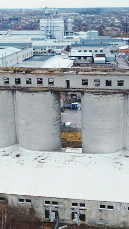 big chemical factory. aerial view of an old building against the backdrop of a new modern factory. vertical video