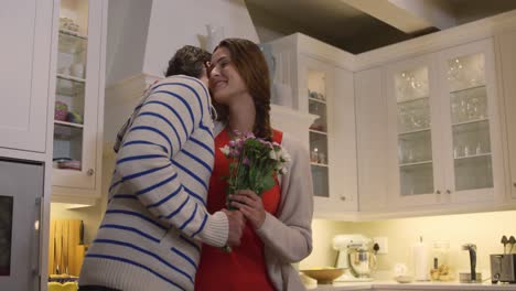 Caucasian-couple-hugging-each-other-in-a-kitchen