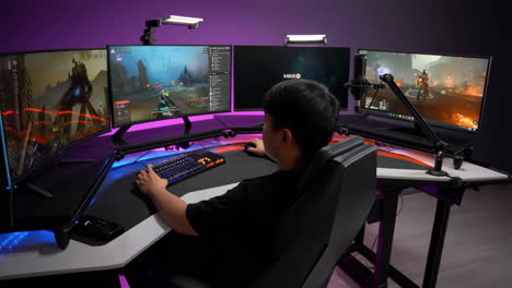 person playing video games on an elaborate multi-monitor pc gaming setup