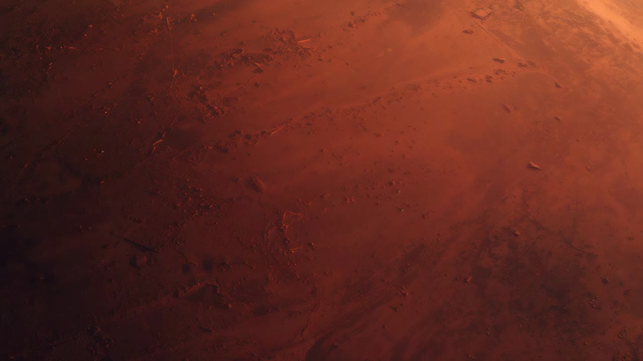 Panning camera revealing red regolith plain from low orbit, exposing scattered craters and lit limb
