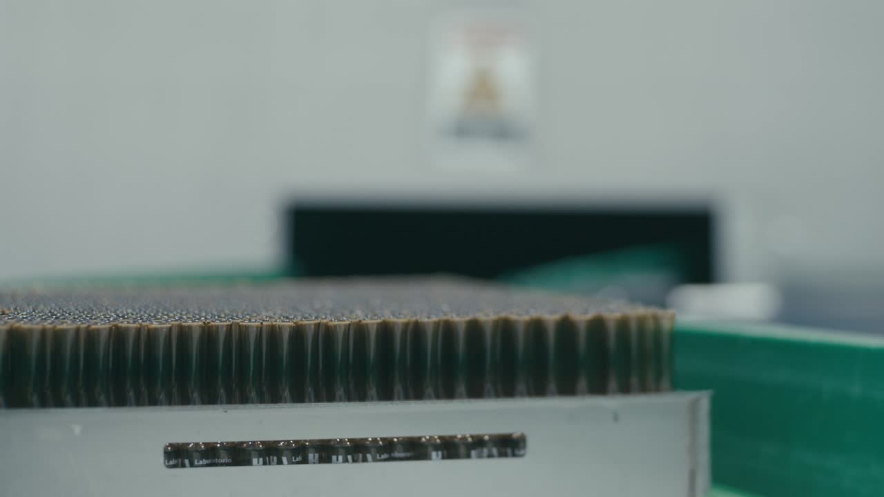 Bottles containing chemical liquids rotating on a conveyor machine in a modern pharmaceutical manufacturing plant