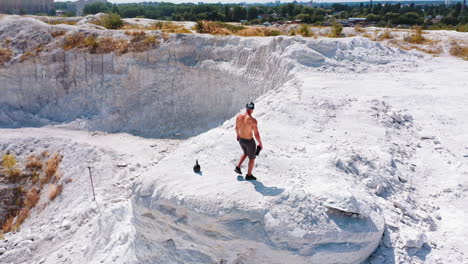 healthy male resting and drinking water after exercising. concept of sport outdoors.