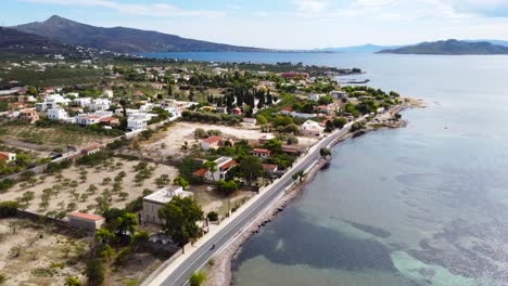 Aerial-drone-bird's-eye-view-photo-of-boats-docked-in-paradise-island-of-Moni-next-to-Aigina-with-emerald-crystal-clear-waters,-Saronic-gulf,-Greece