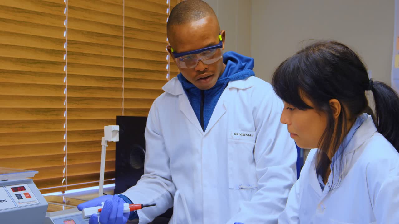Laboratory technicians interacting with each other 4k