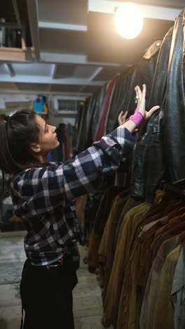 woman browsing vintage clothing store