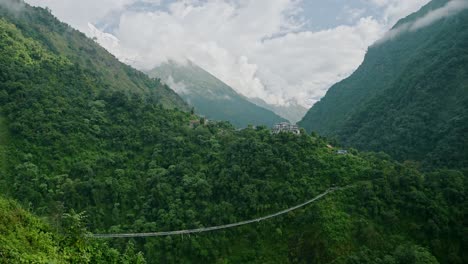 bridge in himalayas mountains in nepal, jhinu danda suspension bridge in the annapurna region on the annapurna sanctuary trek, in the trekking region of nepal with beautiful mountain scenery