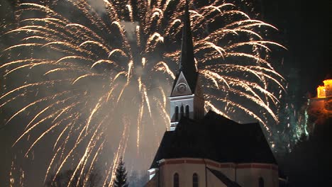 a magnificent fireworks display behind a church 1