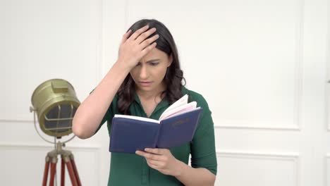 mujer india se sorprende mientras lee un libro