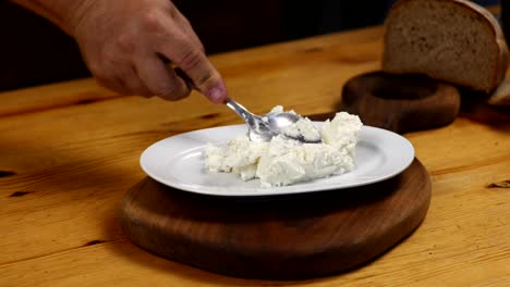 spoon, yogurt, bowl, white plate, wooden floor, kitchen, food, cooking, preparation, ingredients, close-up, top view, natural light, natural setting, organic, healthy, breakfast, snack, vegetarian