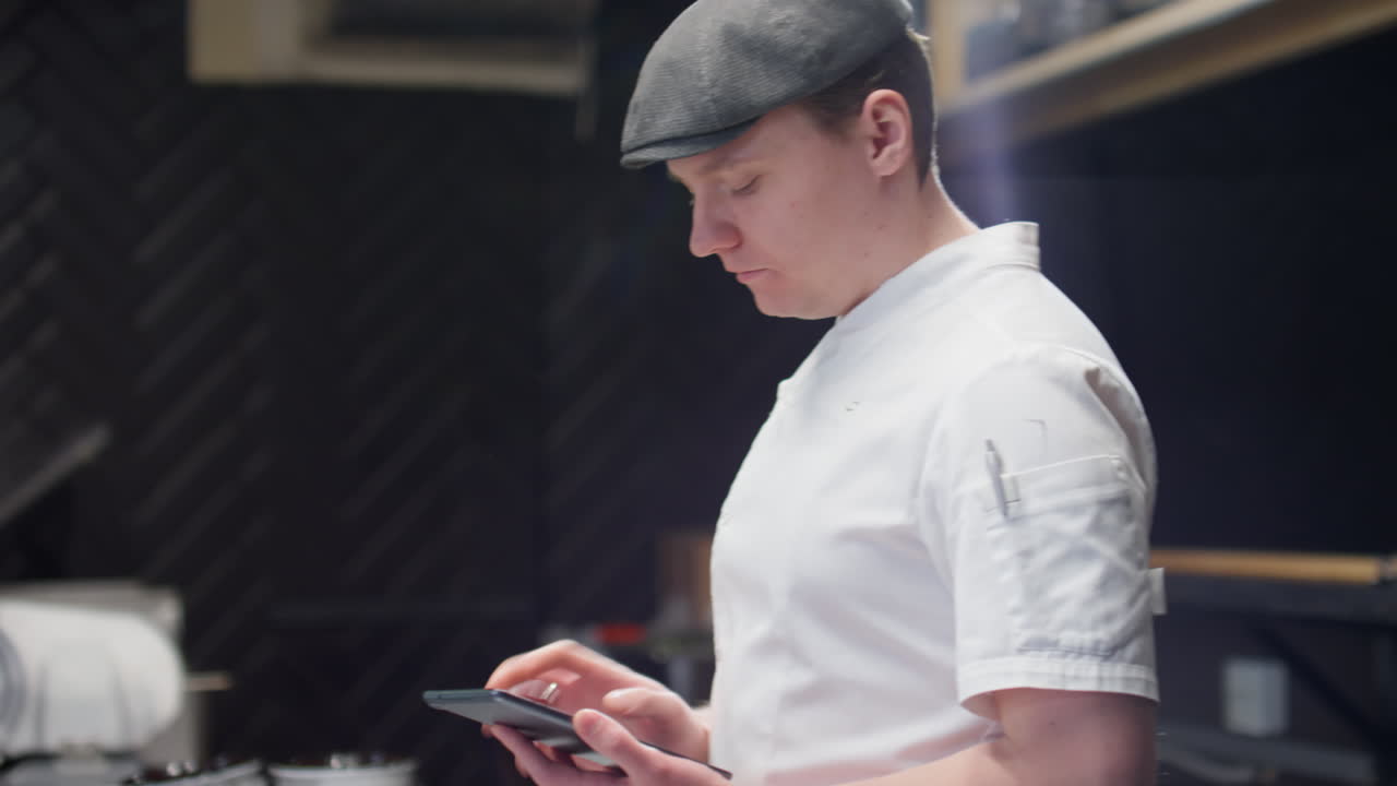 Two Male Chefs Working Together in Restaurant Kitchen