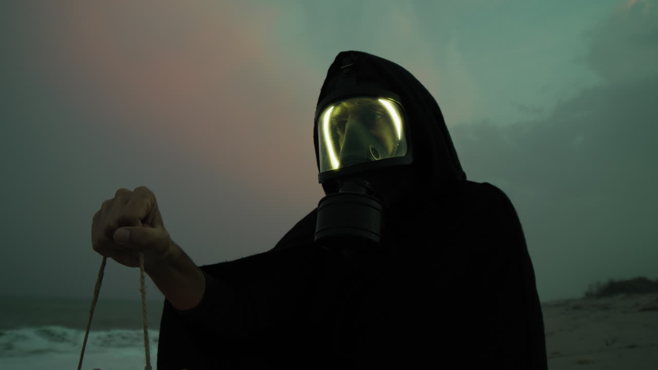Terrified Halloween Man Wearing Gas Mask On Beach