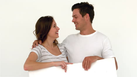 Happy-couple-holding-white-sheet