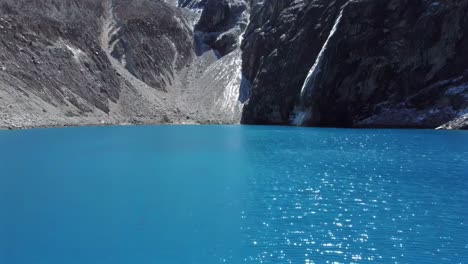aerial of laguna 69 striking blue waters set against the dramatic andes mountains