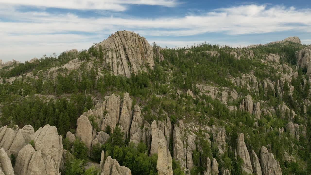 Drone shot flying above towering rock formations carved by nature in the western U.S.