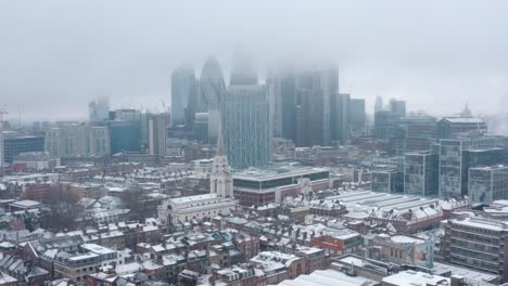 cinematic rotating drone shot of city of london covered in snow