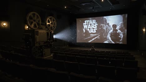 a captivating scene from an old-school cinema, showcasing a classic film projector casting light onto an empty screen in an intimate movie theater setting